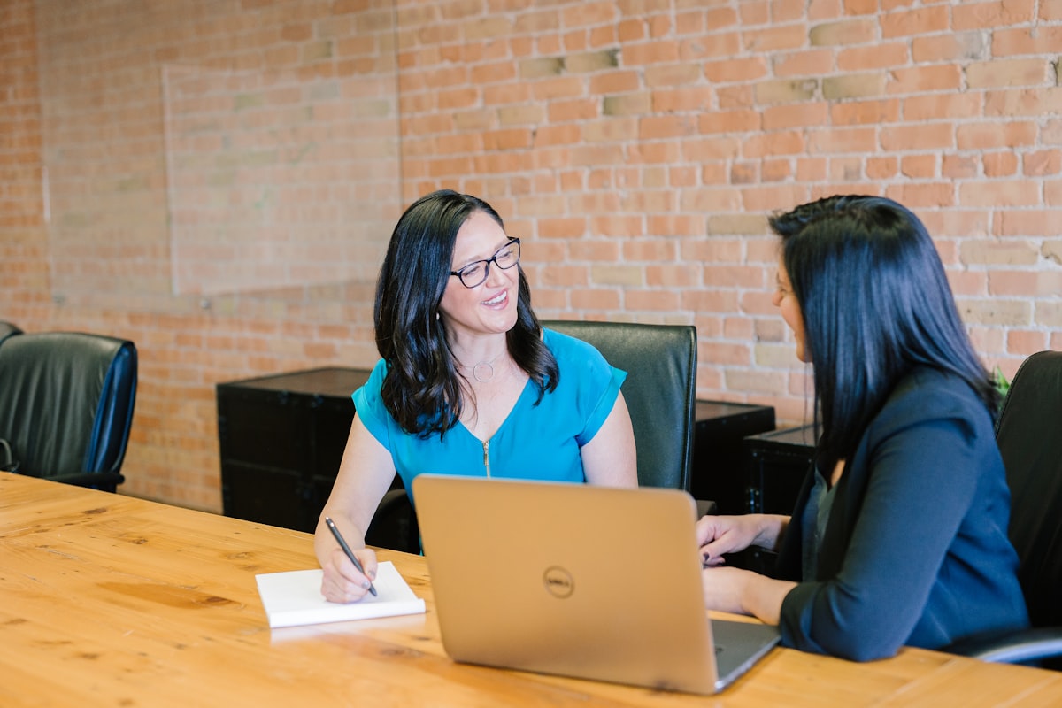 Team discussion with documents spread across a conference table